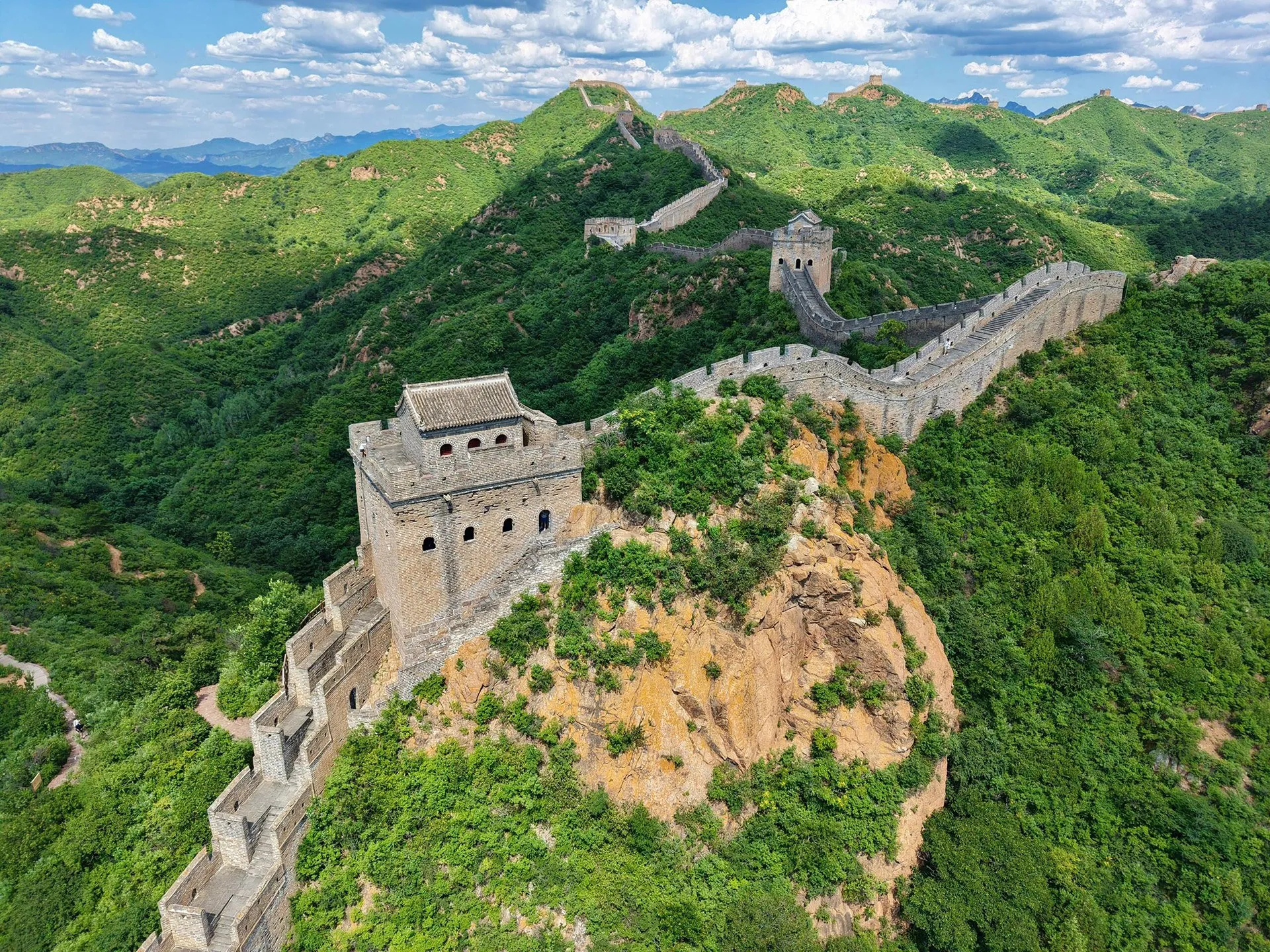 The Great Wall at Jinshanling snaking over green mountain ridges