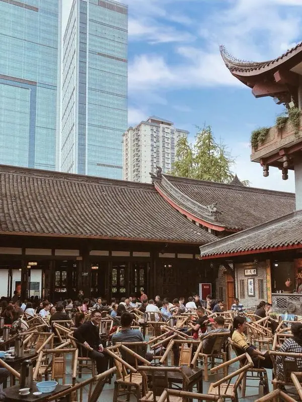 Locals drinking gaiwan tea at bamboo tables at a Chengdu teahouse in People's Park
